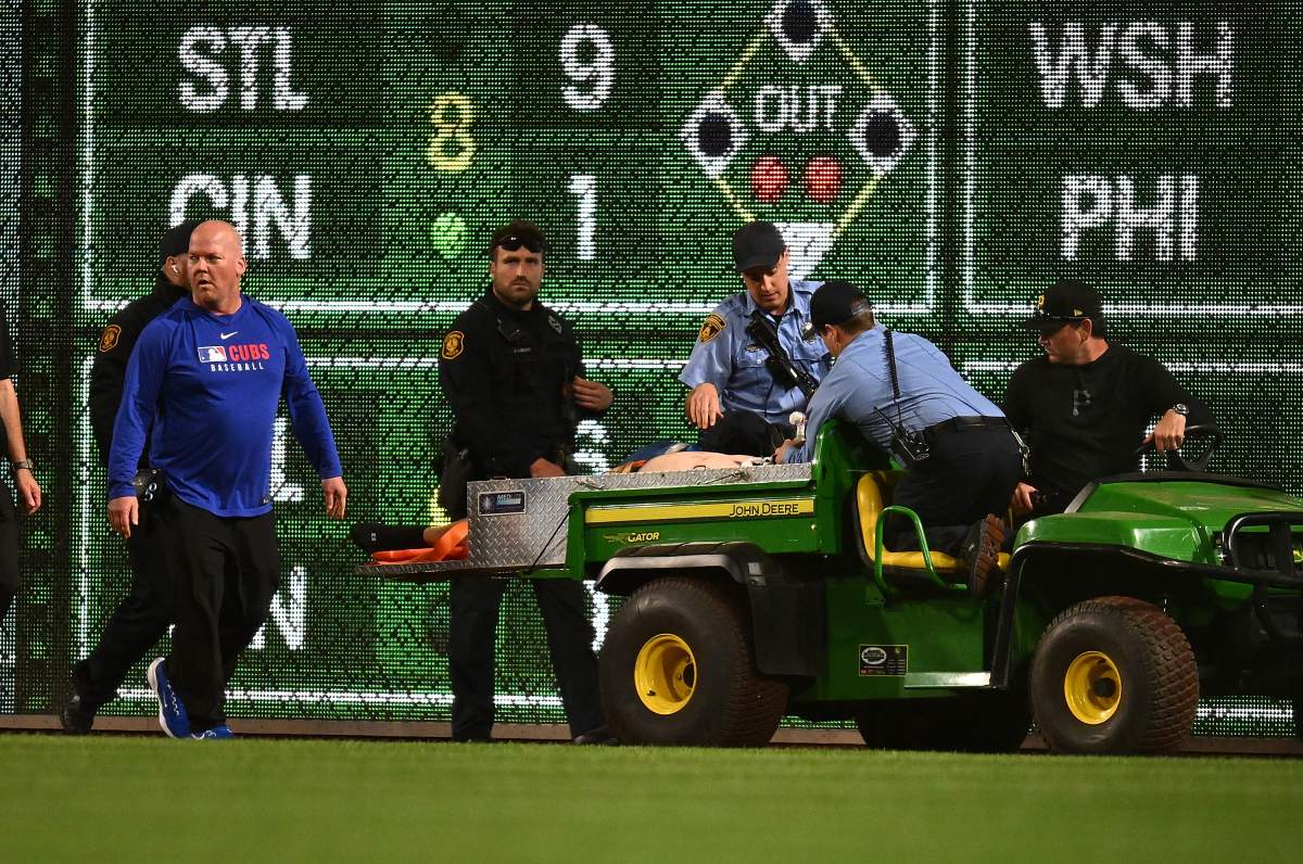 A fan is carted off the field after falling from the stands during the seventh inning of the game between the Chicago Cubs and the Pittsburgh Pirates at PNC Park on April 30, 2025 in Pittsburgh, Pennsylvania.
