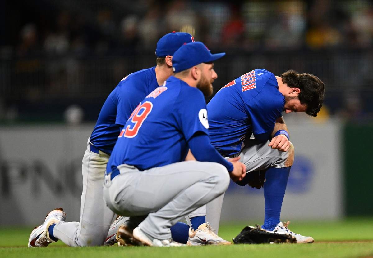 Dansby Swanson No. 7 and Michael Busch No. 29 of the Chicago Cubs look on after a fan fell from the stands during the seventh inning against the Pittsburgh Pirates at PNC Park on April 30, 2025 in Pittsburgh.