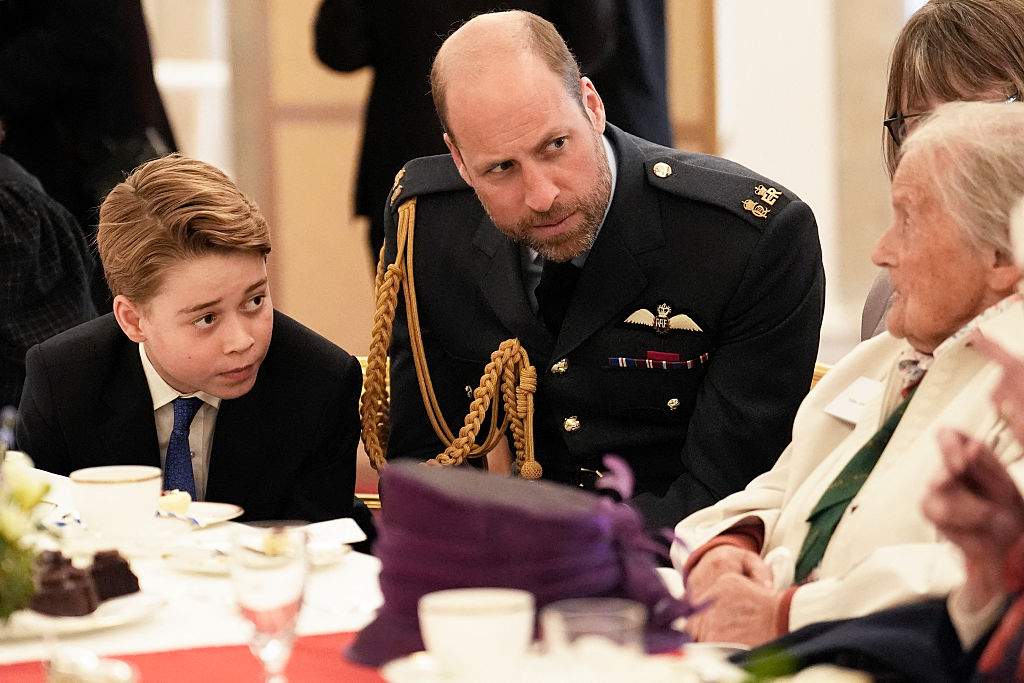 Britain's Prince George of Wales (L) and Britain's Prince William, Prince of Wales (C) speak with Second World War veterans during a tea party at Buckingham Palace on May 5, 2025 to celebrate the 80th anniversary of VE Day also known as Victory in Europe Day, marking the end of the Second World War in Europe.