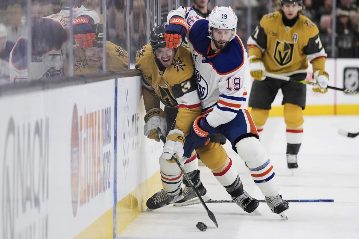 Edmonton Oilers centre Adam Henrique (19) and Vegas Golden Knights defenceman Brayden McNabb (3) battle for the puck during the third period of an NHL hockey game Tuesday, April 1, 2025, in Las Vegas.