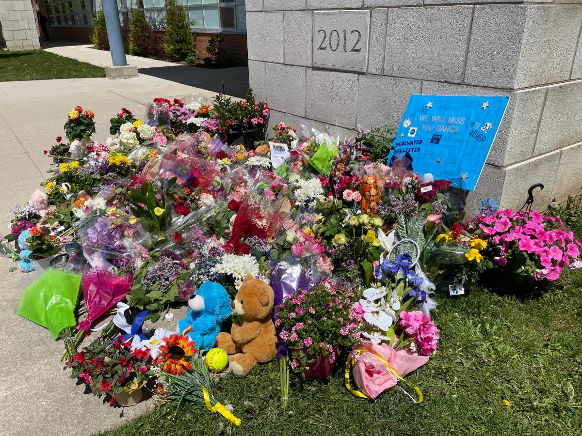 Flowers and stuffed animals outside Walkerton District Community School in Walkerton, Ont. on Sunday, May 25, 2025.