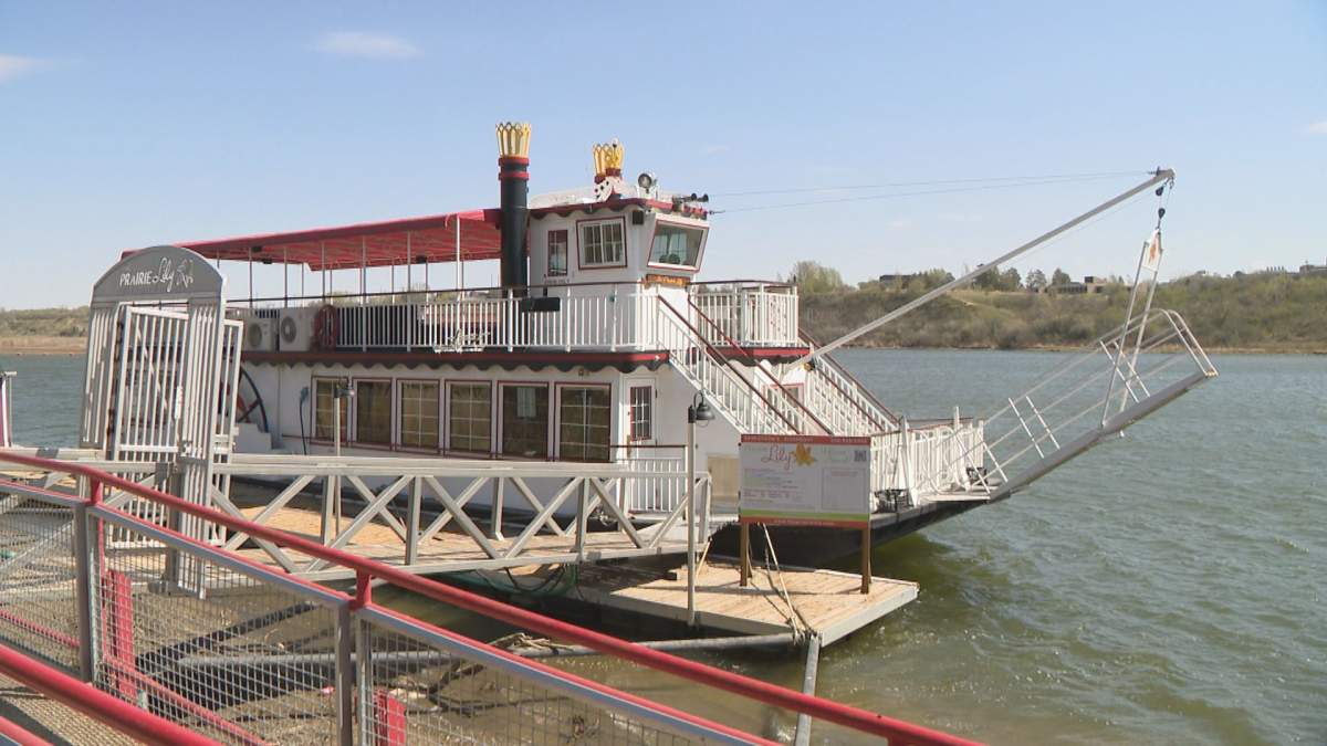 The Prairie Lily Riverboat sits by the dock on the shore of the South Saskatchewan river.