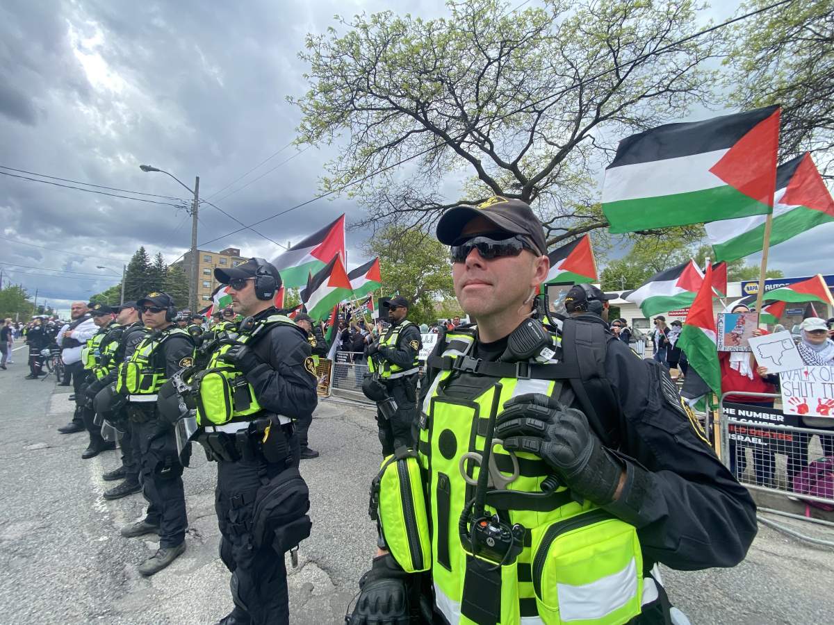 A police line is seen in front of pro-Palestinian protesters behind a barricade at the annual Walk with Israel event in Toronto on May 25, 2025.