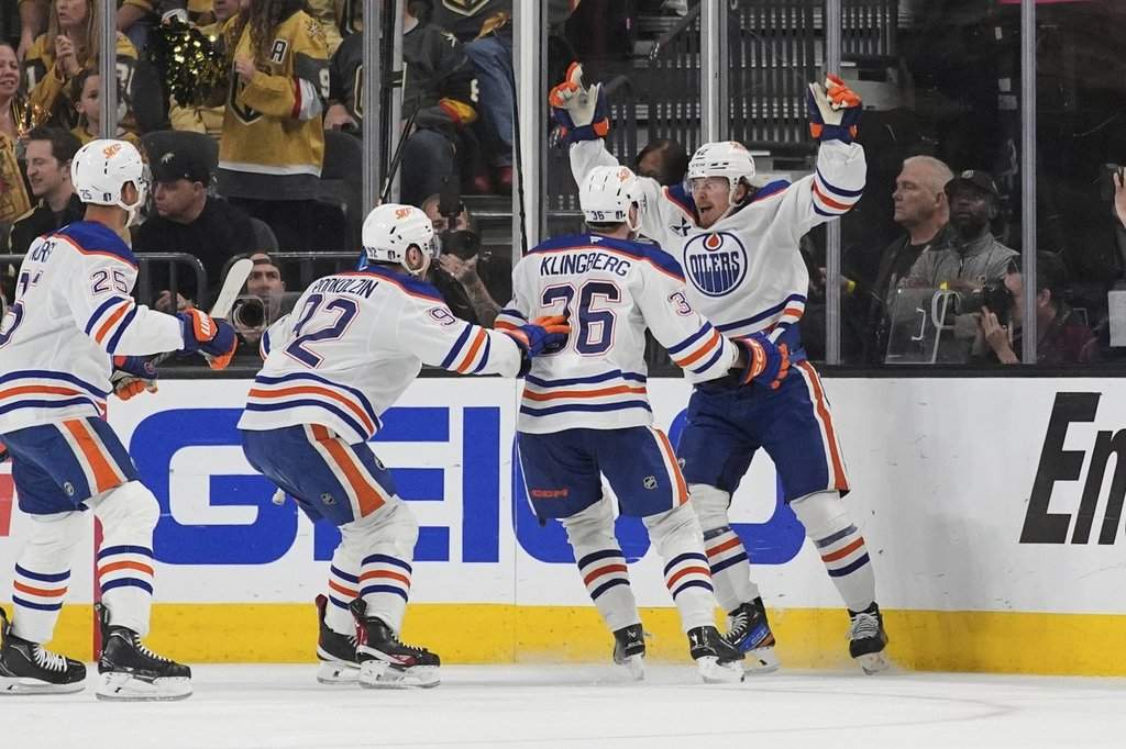 Edmonton Oilers right wing Kasperi Kapanen, right, celebrates with teammates after scoring against the Vegas Golden Knights during overtime of Game 5 of a second-round NHL hockey playoff series Wednesday, May 14, 2025, in Las Vegas.