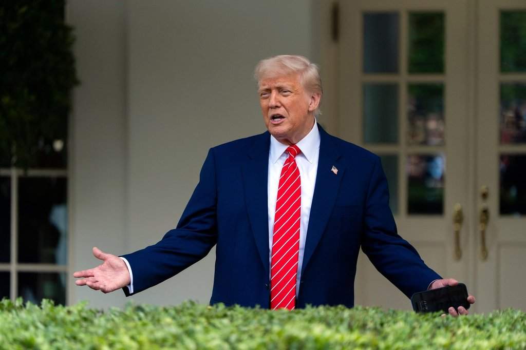 President Donald Trump speaks with reporters in front of the West Wing of the White House, Thursday, May 8, 2025, in Washington. 