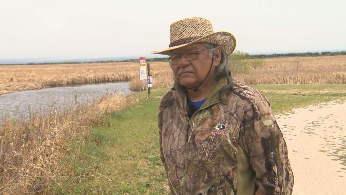 Lake Manitoba First Nation Councillor Dwight Paul stands along the shores of Watchorn Bay on Lake Manitoba, where the proposed flood outlet channel would start.