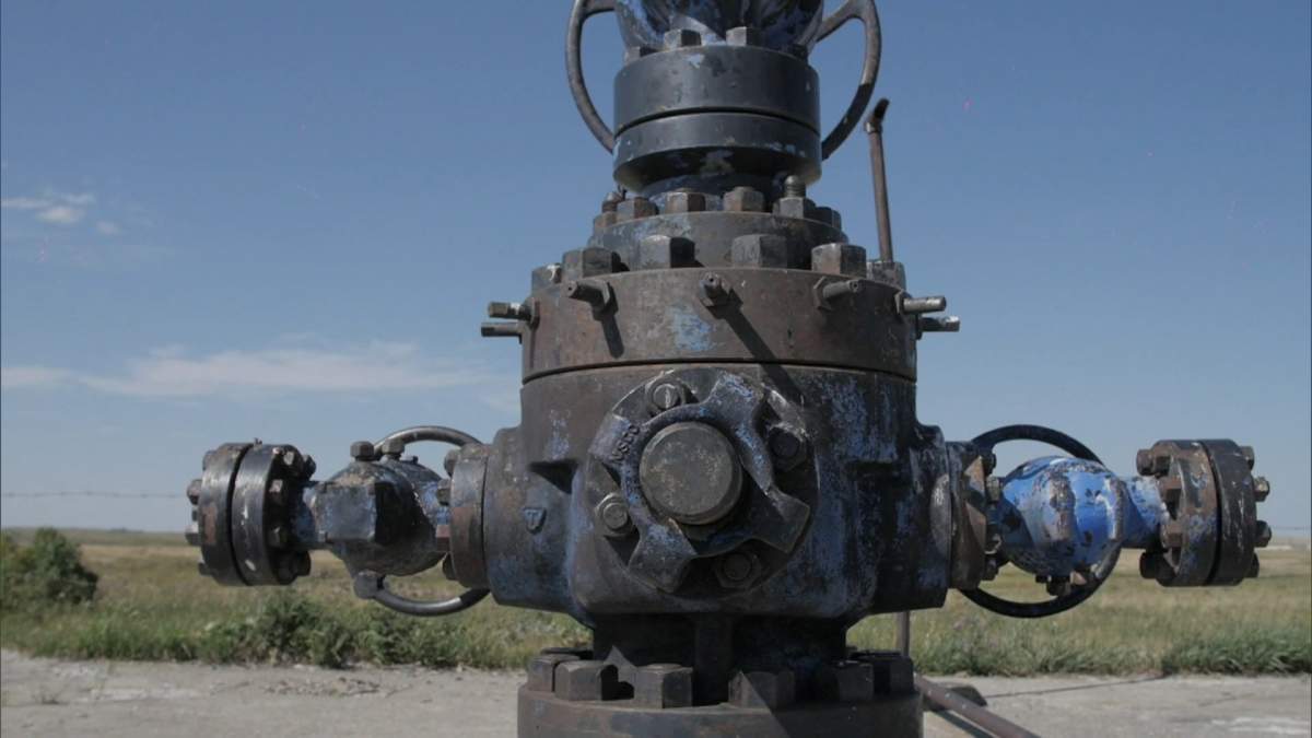 A new report from the University of Calgary's Public Interest Law Clinic estimates the amount of money charged to oil companies to clean up abandoned wells is more than $1 billion short of what the cleanup will cost.