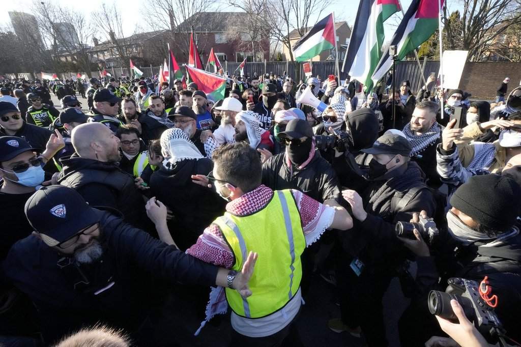 Pro-Palestine protesters and pro-Israel protesters face off at a demonstration at a synagogue in Thornhill, Ont., Thursday, March 7, 2024. 