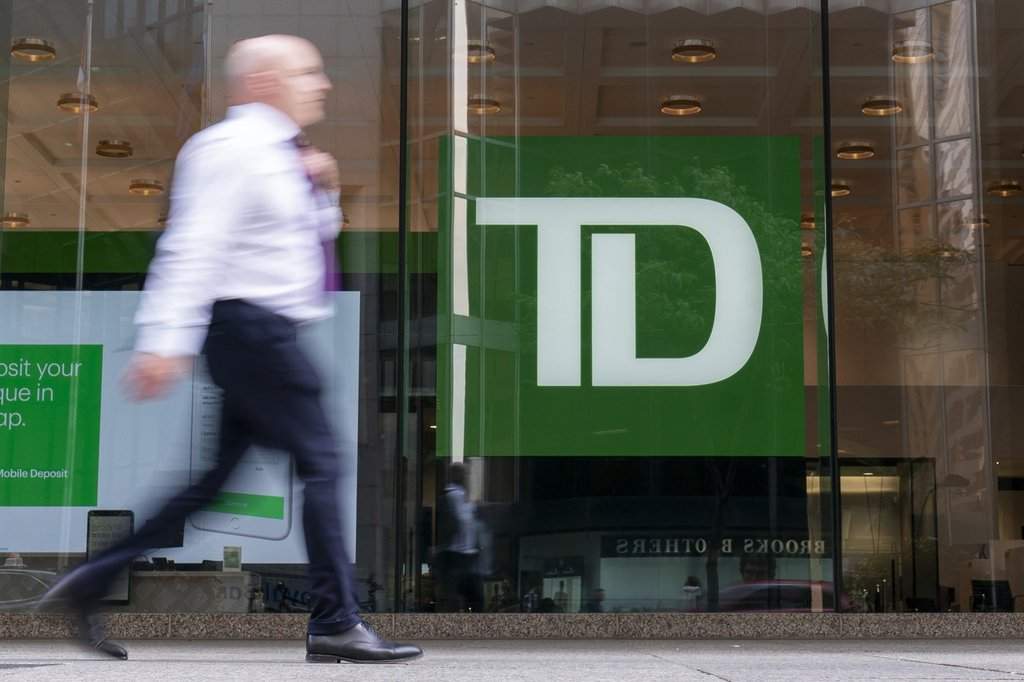 A person makes their way past a Toronto-Dominion Bank in the Financial District of Toronto, Monday, Aug. 14, 2023. THE CANADIAN PRESS/Spencer Colby.
