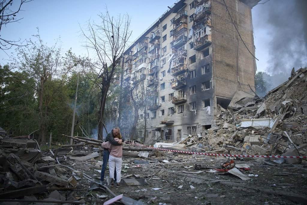 Residents react after a Russian missile hit a multi-storey apartment during Russia’s combined missile and drone air attack in Kyiv, Ukraine, Tuesday, June 17, 2025.