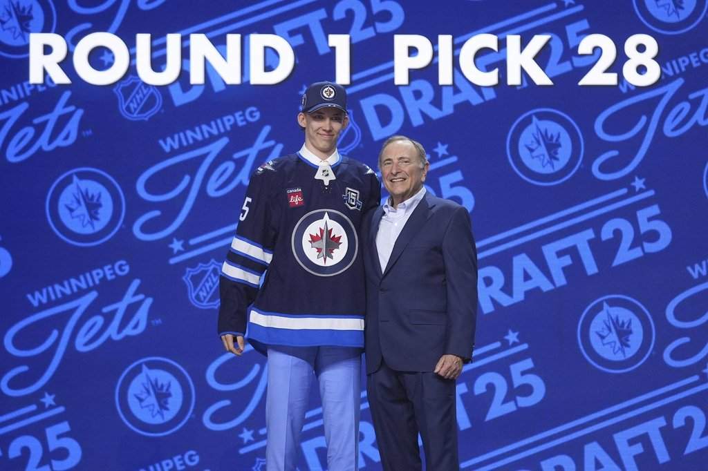 Sascha Boumedienne, left, stands with NHL commissioner Gary Bettman after being drafted by the Winnipeg Jets during the NHL hockey draft Friday, June 27, 2025, in Los Angeles.