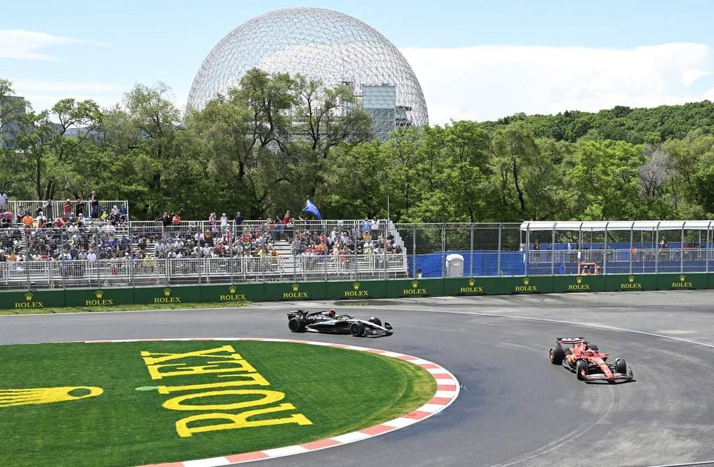 Ferrari driver Charles Leclerc of Monaco, right, and Mercedes driver Lewis Hamilton of Great Britain steer their car at the hairpin during the first practice session, Friday, June 7, 2024, at the Canadian Grand Prix in Montreal. THE CANADIAN PRESS/Jacques Boissinot.