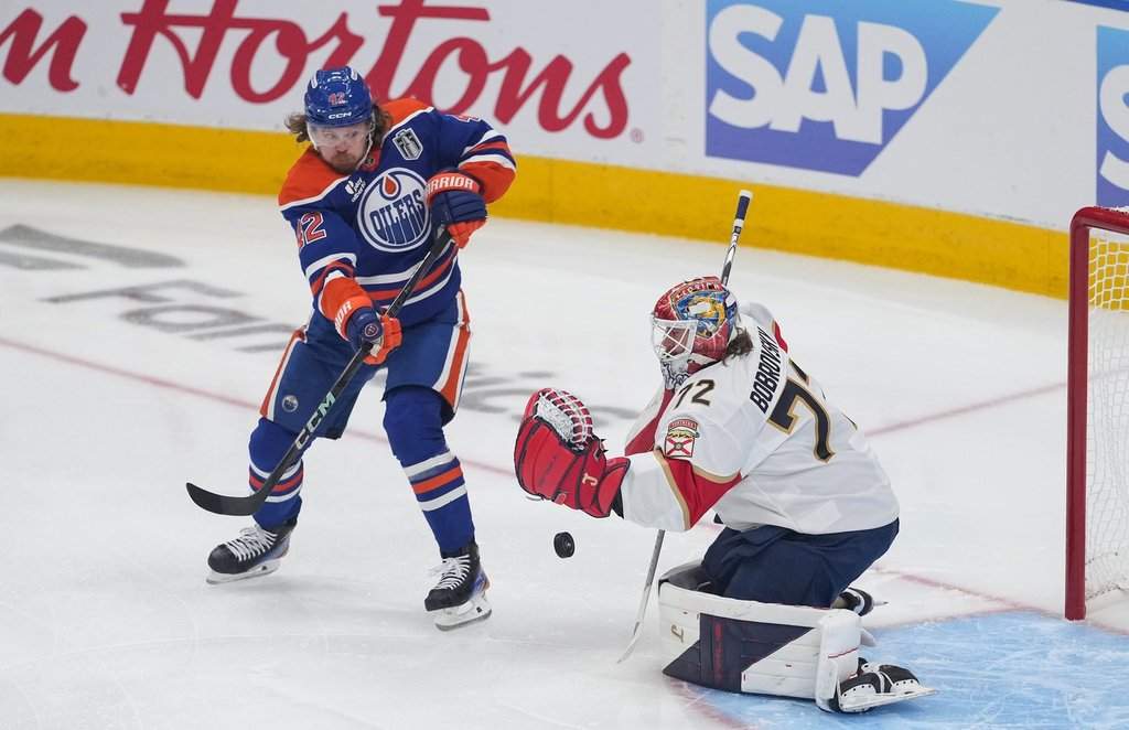 Oilers winger Kasperi Kapanen (42) tries to redirect the puck as Florida Panthers goalie Sergei Bobrovsky (72) makes the save in Game 1 of Stanley Cup final in Edmonton on Wednesday, June 4, 2025.