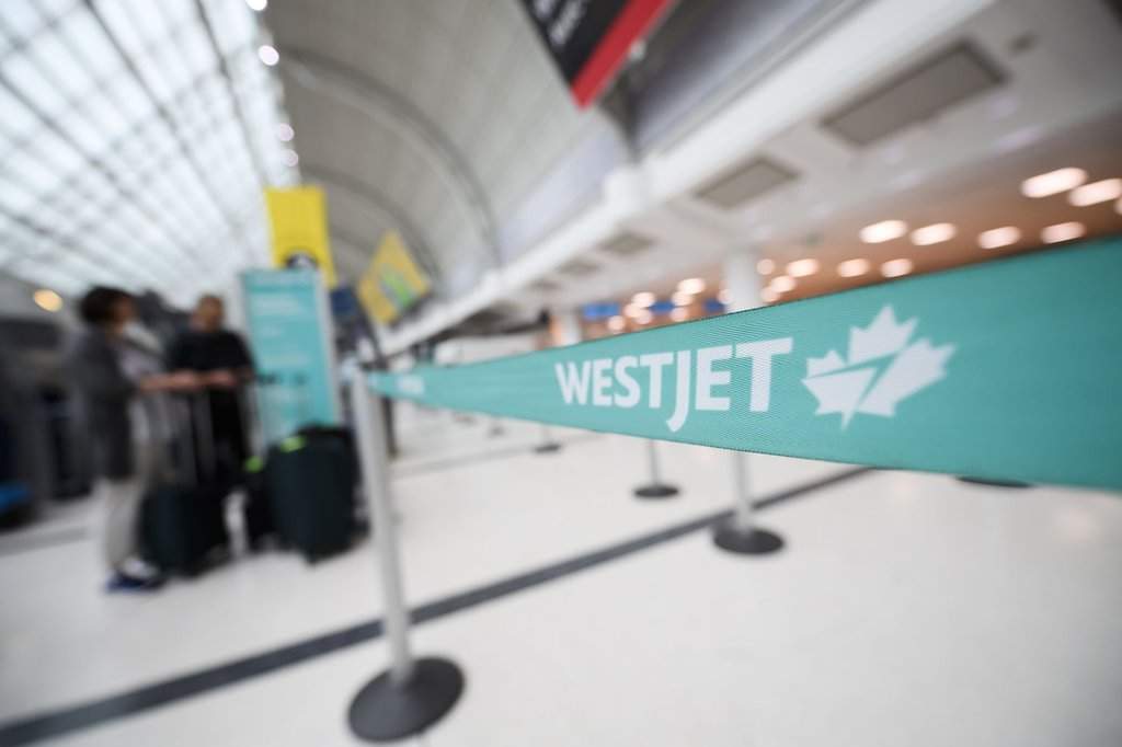 The WestJet check-in area at Pearson International Airport is photographed in Toronto, Saturday, June 29, 2024. THE CANADIAN PRESS/Christopher Katsarov”.
