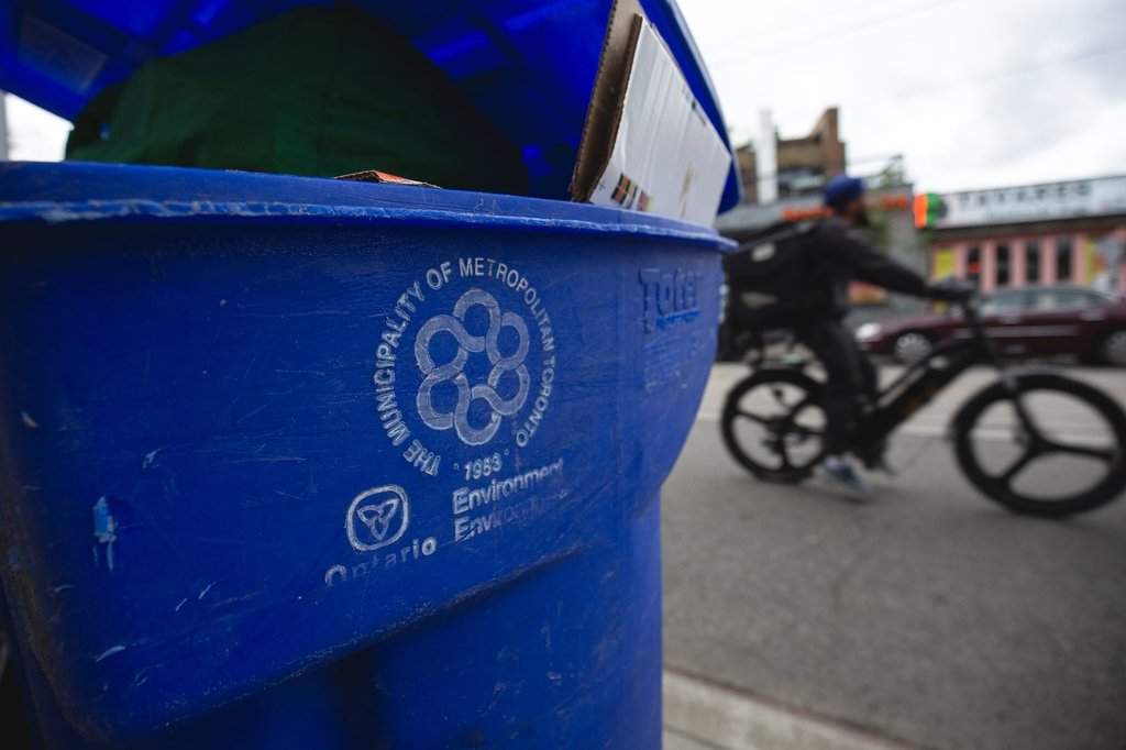 Old Metropolitan Toronto signage and Ontario provincial insignia are seen on a blue recycling box at the side of the street on a weekly collection day in Toronto, Tuesday, June 17, 2025. THE CANADIAN PRESS/Giordano Ciampini.