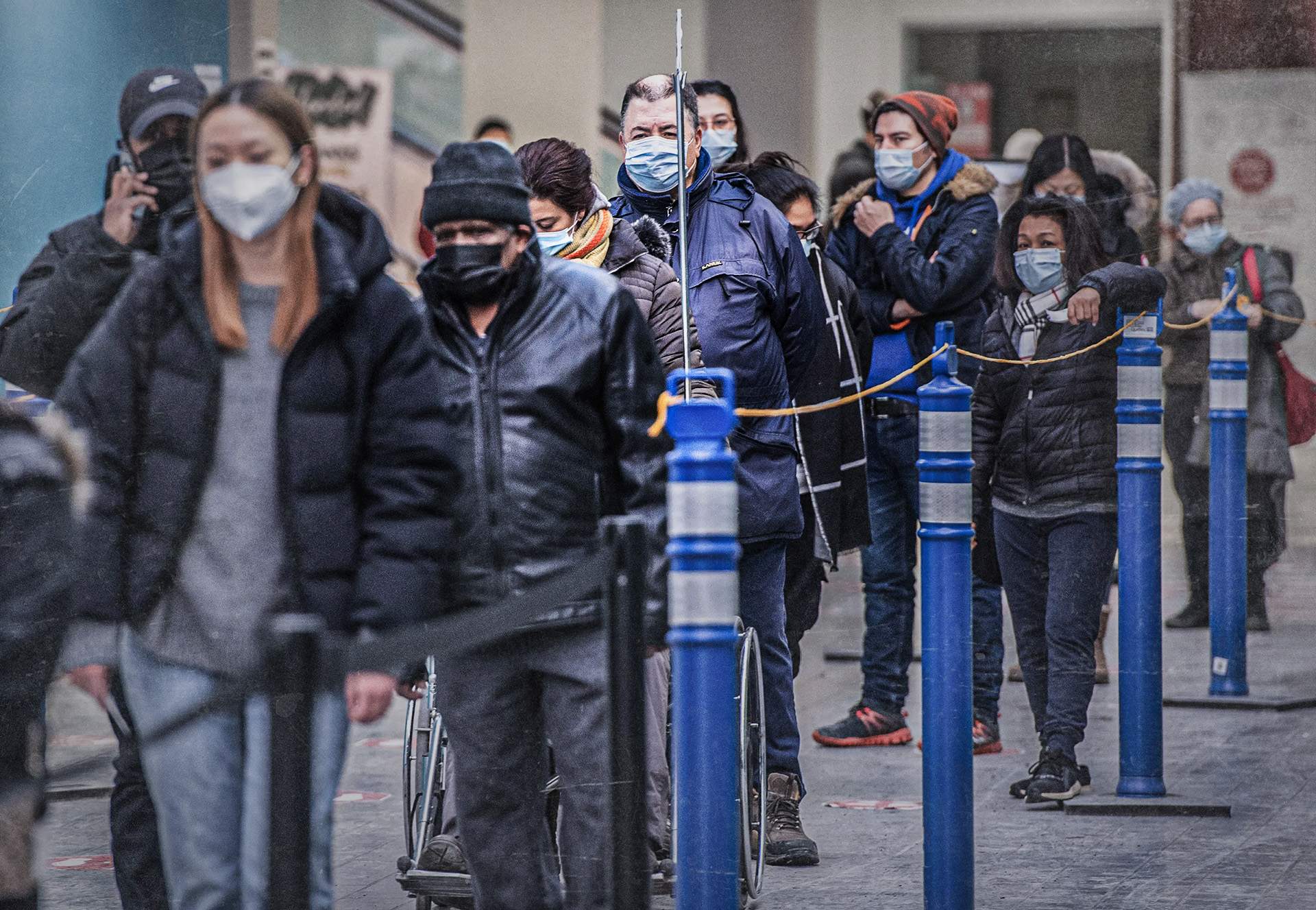 People wait in line at a COVID-19 vaccination site in Montreal in January 2022.