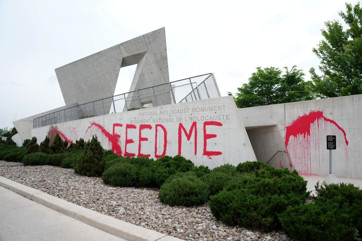 The words ‘FEED ME’ are seen painted in red on the National Holocaust Monument in Ottawa on Monday, June 9, 2025.