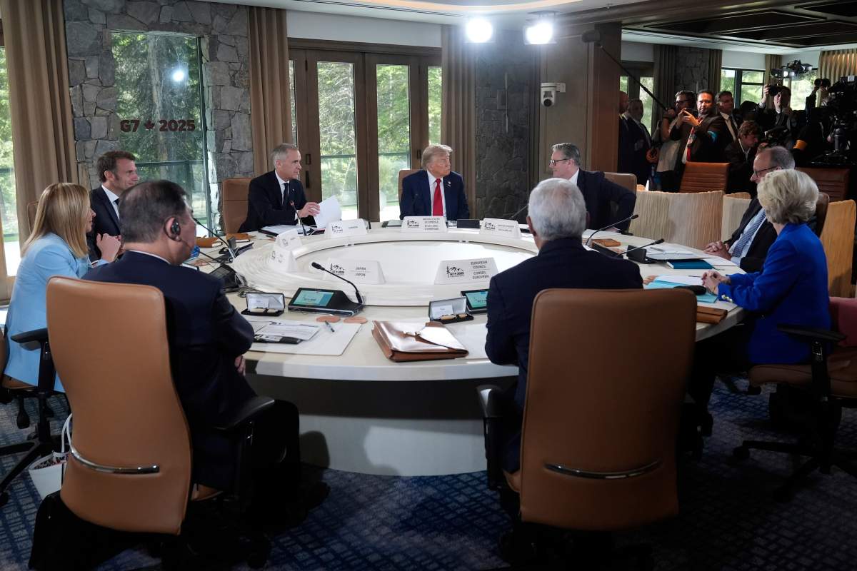 Italy’s Prime Minister Giorgia Meloni, from left, France’s President Emmanuel Macron, Canada’s Prime Minister Mark Carney, President Donald Trump, Britain’s Prime Minister Keir Starmer and Germany’s Chancellor Friedrich Merz participate in a session of the G7 Summit, Monday, June 16, 2025, in Kananaskis, Canada. Japan’s Prime Minister Shigeru Ishiba, European Council President António Costa and European Commission President Ursula von der Leyen are also at the table. (AP Photo/Mark Schiefelbein)