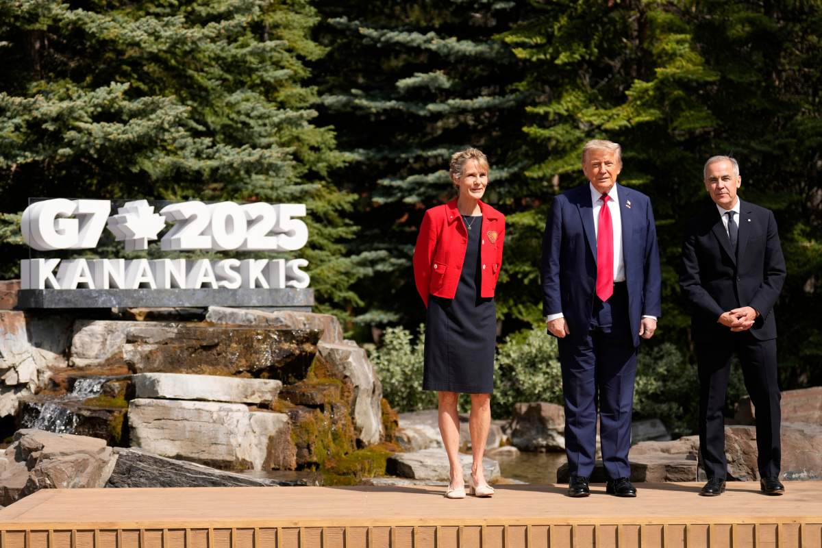 Canada’s Prime Minister Mark Carney, right, and his wife Diana Fox Carney, left, pose with President Donald Trump during the official welcome of the G7 Summit, Monday, June 16, 2025, in Kananaskis, Canada. (AP Photo/Mark Schiefelbein)