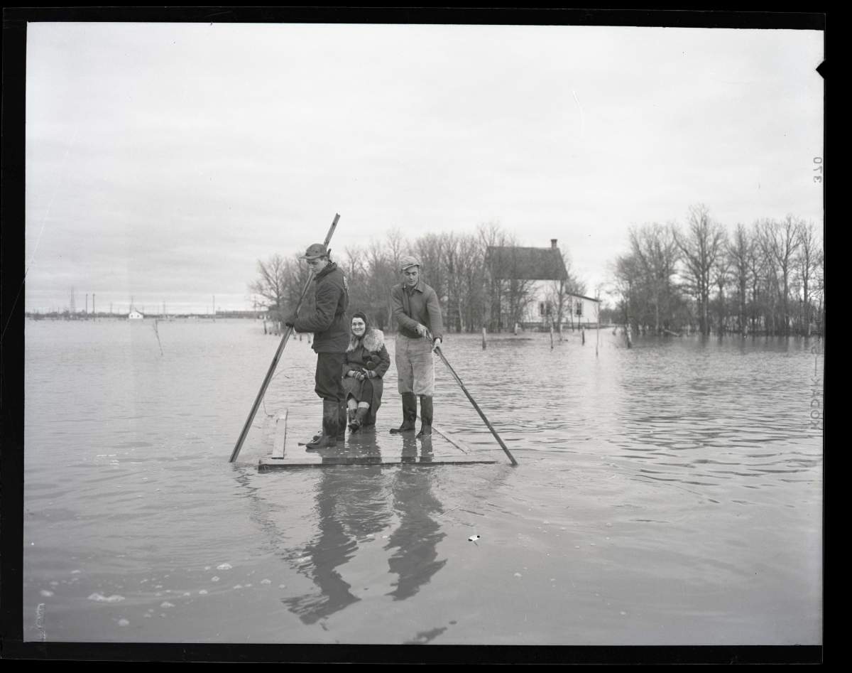 People fleeing their homes via a raft.
