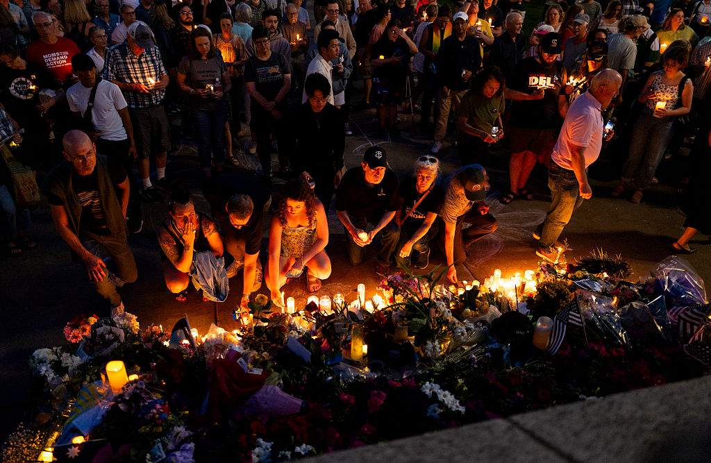 People lay down their candles at a memorial on the steps outside the Minnesota State Capitol building during a candlelight vigil on June 18, 2025 in St. Paul, Minnesota.