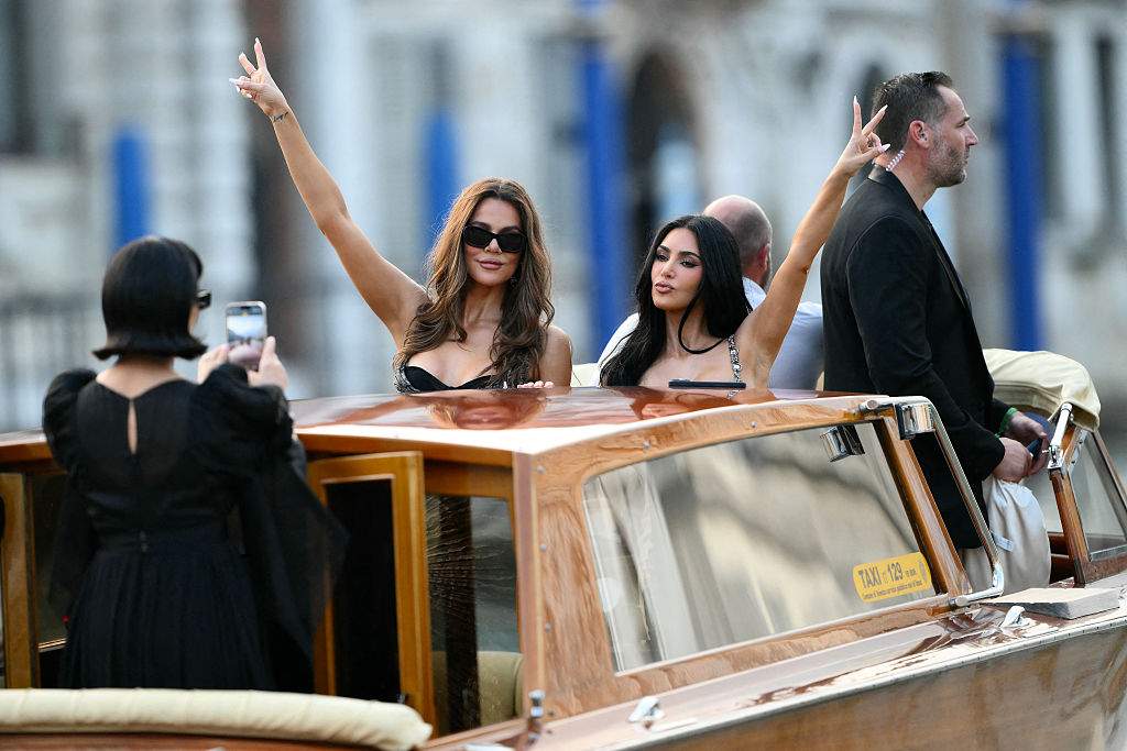 Kris Jenner takes pictures of Khloe and Kim Kardashian on a taxi boat as they leave the Gritti Palace Hotel ahead of the wedding of Amazon's founder Jeff Bezos with Lauren Sanchez in Venice on June 26, 2026.