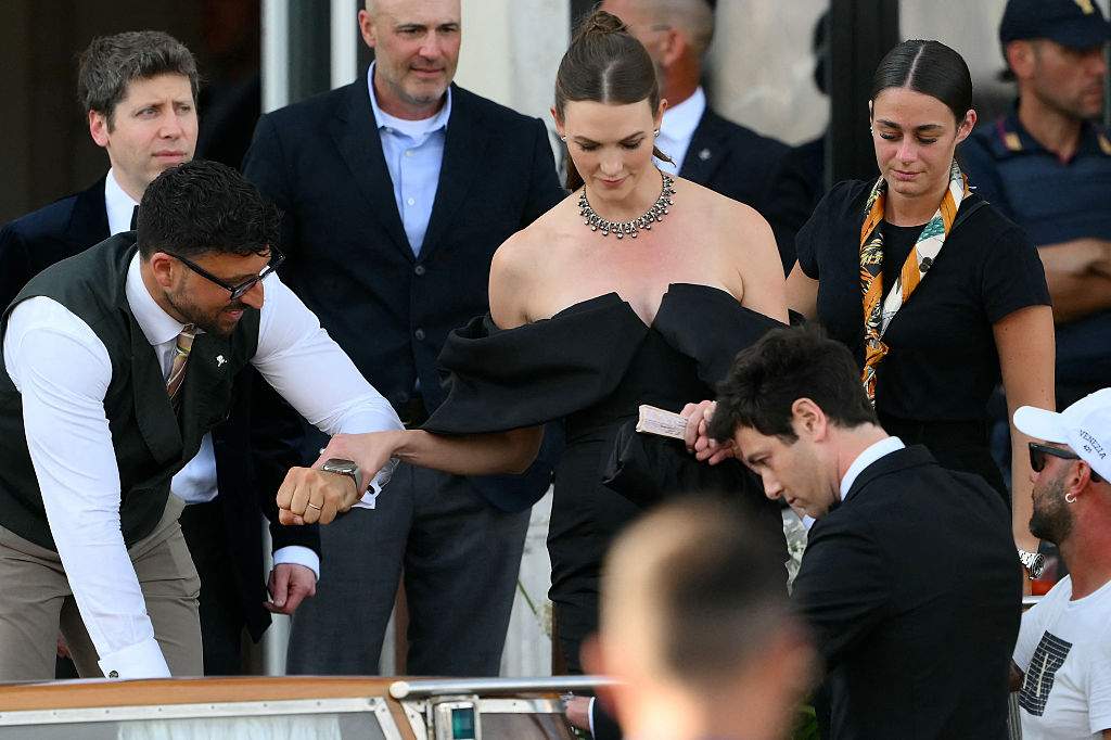 Sam Altman (L) and US model Karlie Kloss leave the St Regis Hotel on the wedding day of Amazon founder Jeff Bezos with Lauren Sanchez, in Venice on June 27, 2025.