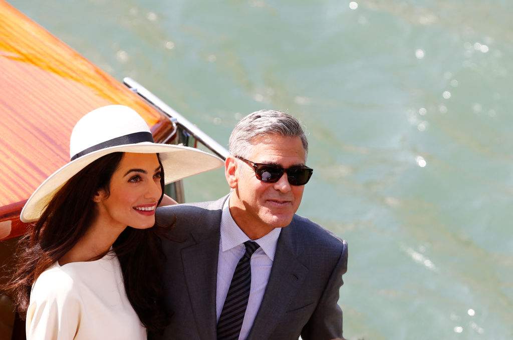 U.S. actor George Clooney and British lawyer Amal Alamuddin leave the palazzo Ca Farsetti on a taxi boat on September 29, 2014 in Venice, after a civil ceremony to officialise their wedding.