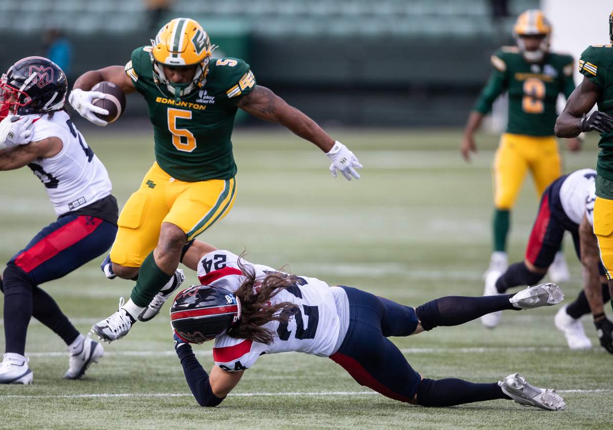 Montreal Alouettes' Marc-Antoine Dequoy (24) misses the tackle on Edmonton Elks' Justin Rankin (5) during first half CFL action in Edmonton, on Thursday June 19, 2025.