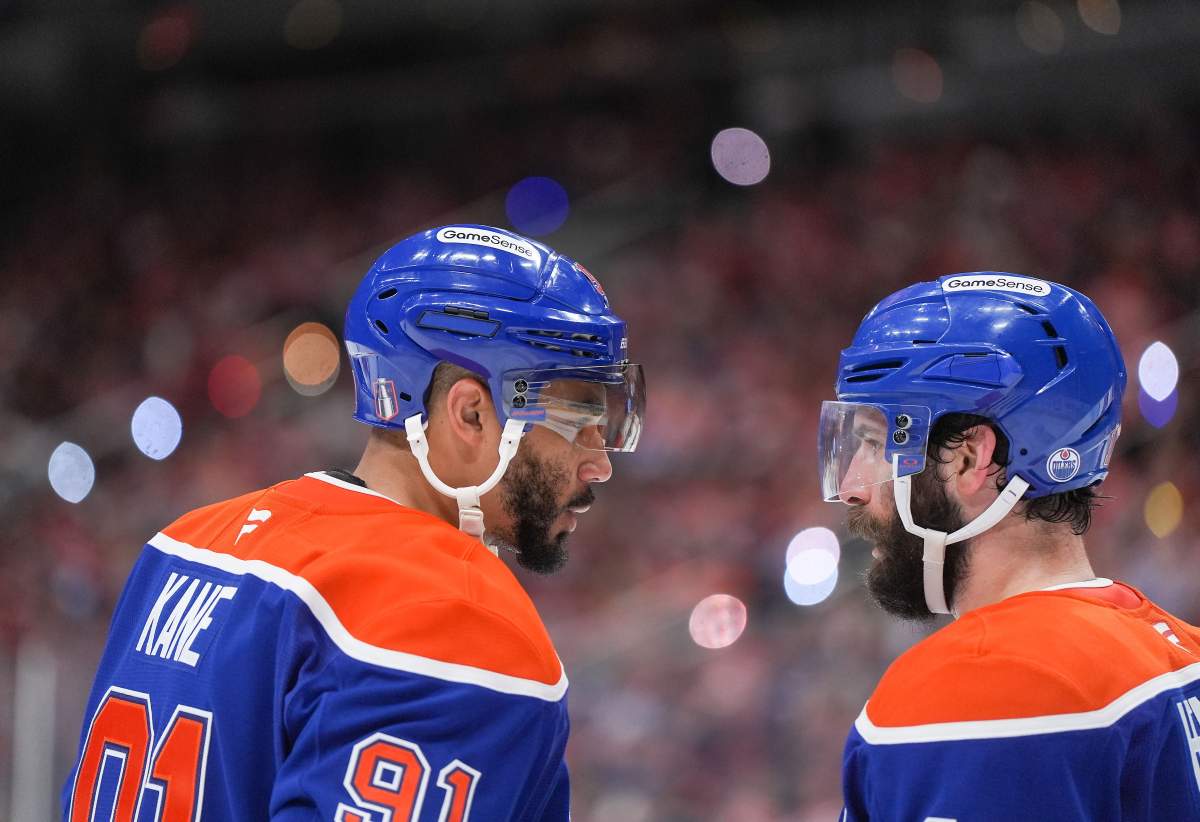 Edmonton Oilers' Evander Kane, left, talks to Adam Henrique before a faceoff during third period of Game 5 of the NHL Stanley Cup final against the Florida Panthers, in Edmonton, on Saturday, June 14, 2025.