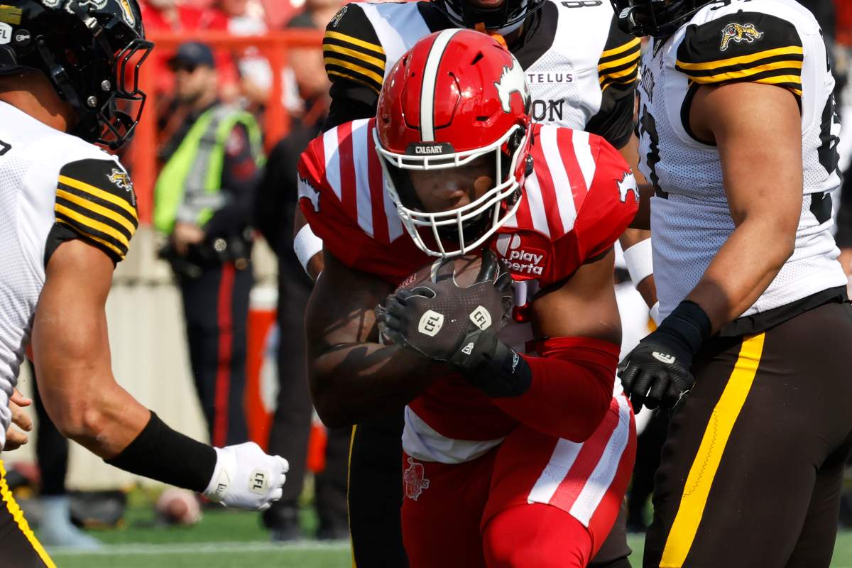 Calgary Stampeders' Dedrick Mills runs into the endzone for a touchdown during first half CFL football action against the Hamilton Tiger-Cats in Calgary, on Saturday, June 7, 2025.