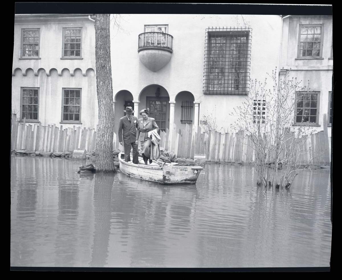 Residents get into a boat to leave their Wellington Crescent home.