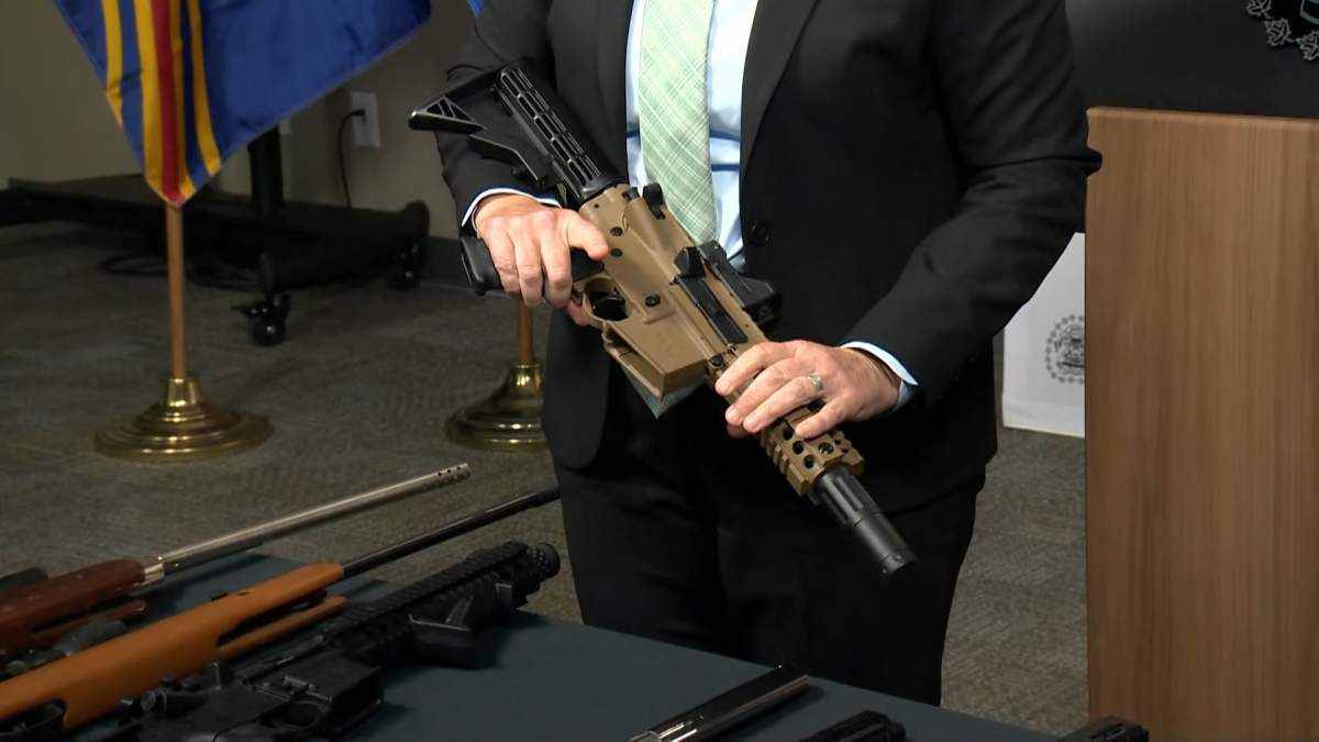 Staff Sgt. Chris Tudor from the Calgary police firearms investigative unit, shows how an airgun can closely resemble a real gun, during a media briefing on Tuesday.