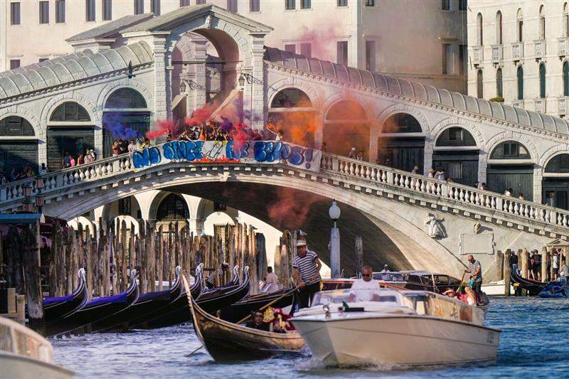Activists stage a protest on the Rialto Bridge in Venice, Italy, Saturday, June 28, 2025, denouncing the three-day celebrations for the wedding between Jeff Bezos and his wife Lauren Sanchez Bezos that took place in Venice on Friday as a symbol of rising inequality and disregard for the city's residents.