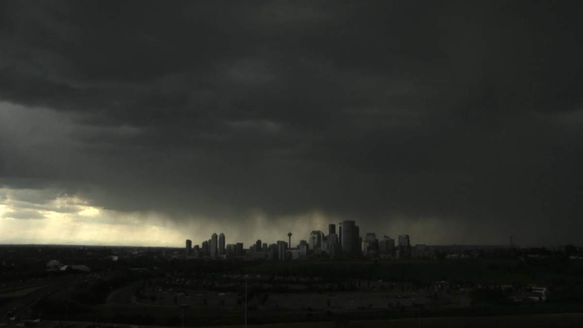 Environment Canada issued a severe thunderstorm warning for Calgary and surrounding area on Tuesday as large, dark clouds accompanied by thunder, lighting, hail and heavy rain could be seen descending on the city from the west.