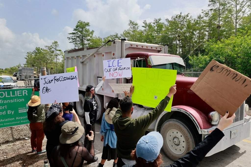 Environmental advocates and protesters at the Dade-Collier Training and Transition Airport on Tamiami Trail E, Ochopee, Fla., on Saturday, June 28, 2025, object to the "Alligator Alcatraz" being built at the facility. (Mike Stocker /South Florida Sun-Sentinel via AP).