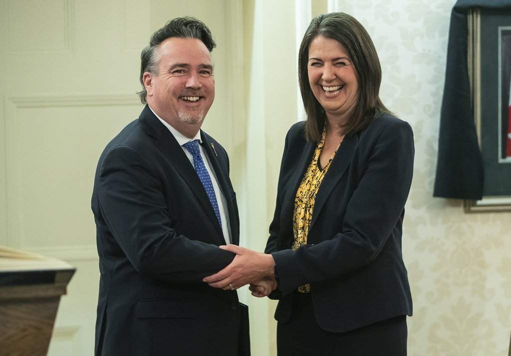 Dale Nally shakes hands with Alberta Premier Danielle Smith after Nally was sworn into cabinet as Minister of Service Alberta and Red Tape Reduction in Edmonton, Monday, Oct. 24, 2022.