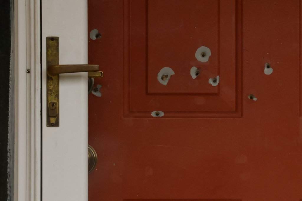 Bullet holes mark the front door of the house of Minnesota state Sen. John Hoffman and his wife who were shot earlier in the day, Saturday, June 14, 2025, in Champlin, Minn.