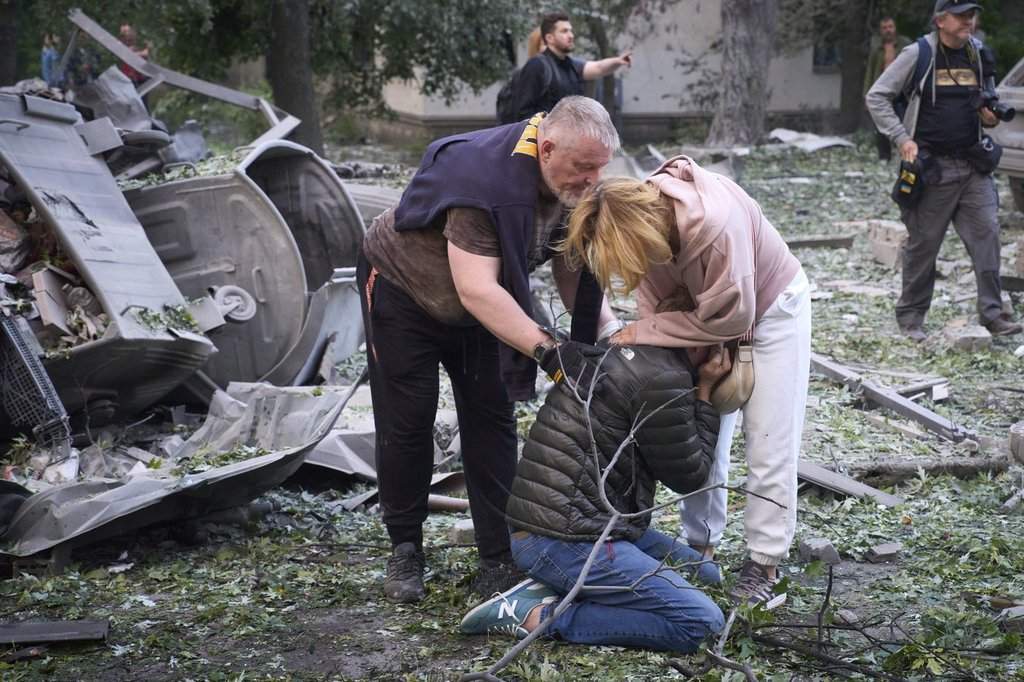 Residents react after a Russian missile hit a multi-storey apartment during Russia’s massive missile and drone air attack in Kyiv, Ukraine, Tuesday, June 17, 2025.