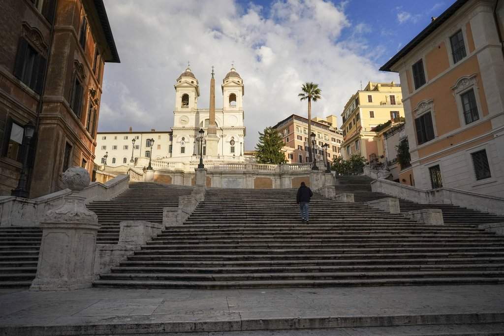 FILE - A man walks up the historical Spanish Steps, in Rome, Friday, Nov. 20, 2020.