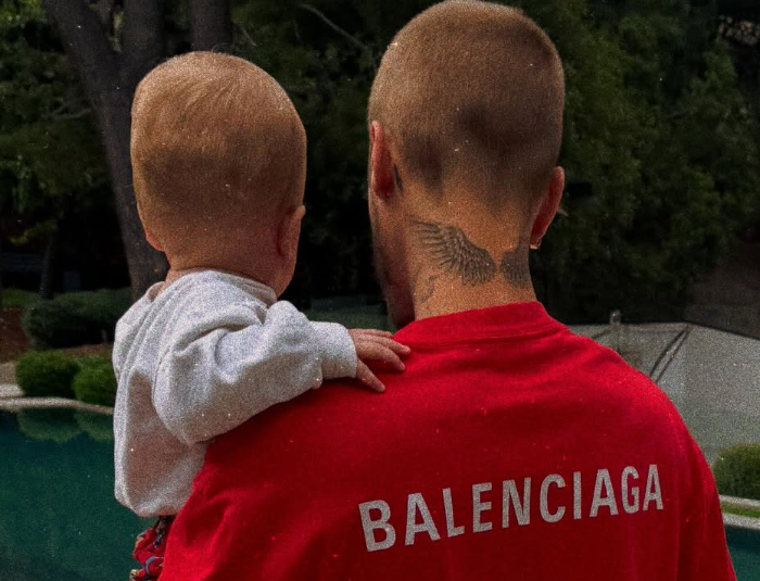 Justin Bieber and Jack Blues stand by a pool.