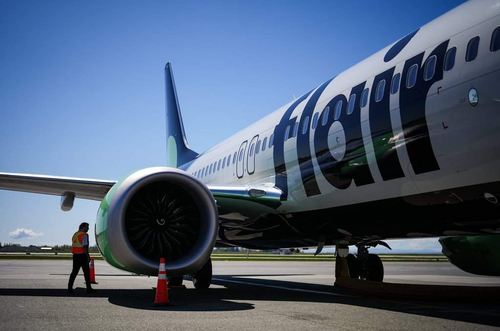 A Flair Airlines captain inspects the outside of one of the company's Boeing 737 MAX 8 aircraft while parked at a gate at Vancouver International Airport, in Richmond, B.C., on April 17, 2024.