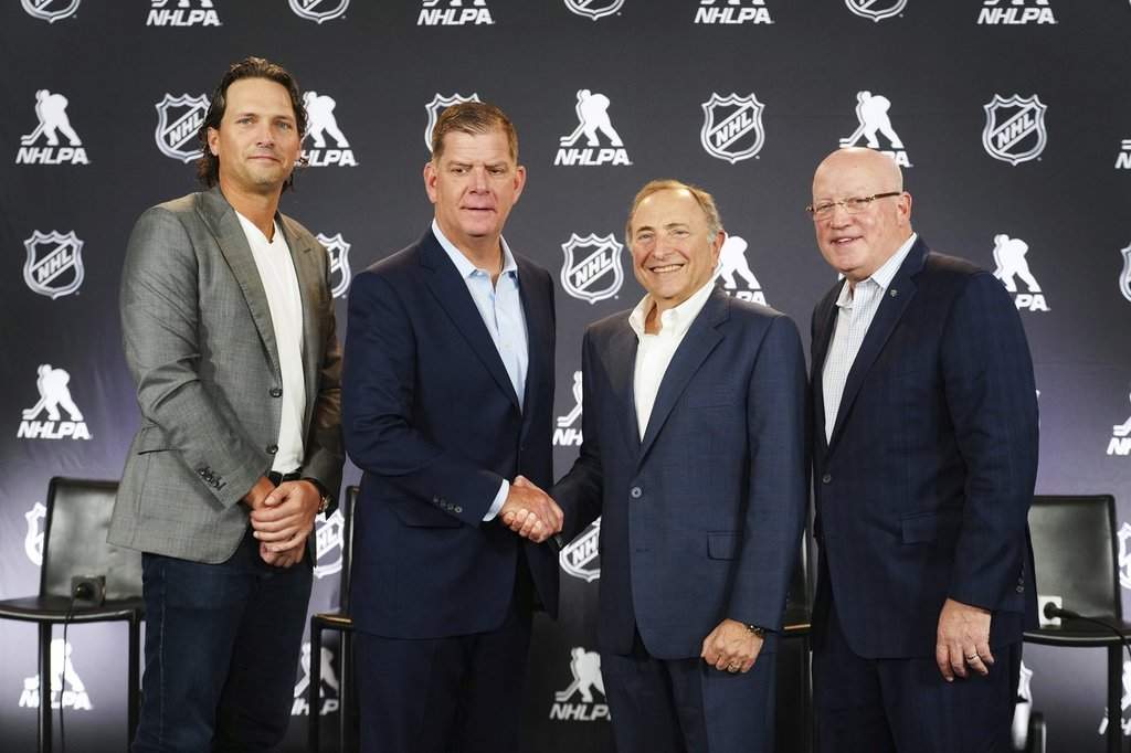From left to right, Ron Hainsey, NHLPA Assistant Executive Director, Marty Walsh, NHLPA Executive Director, Gary Bettman, NHL Commissioner, and Bill Daly, NHL Deputy Commissioner, pose for photos after a joint press conference before the NHL hockey draft Friday, June 27, 2025, in Los Angeles.