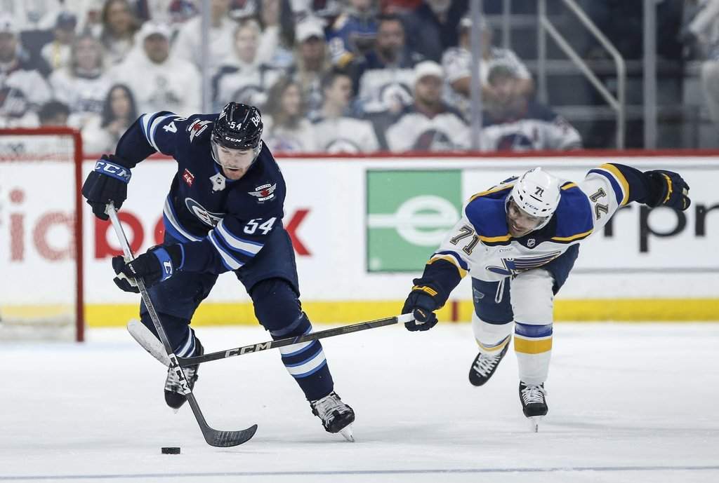 Winnipeg Jets' Dylan Samberg (54) breaks away from St. Louis Blues' Mathieu Joseph (71) during second-period NHL playoff action in Winnipeg on Saturday, April 19, 2025. THE CANADIAN PRESS/John Woods.