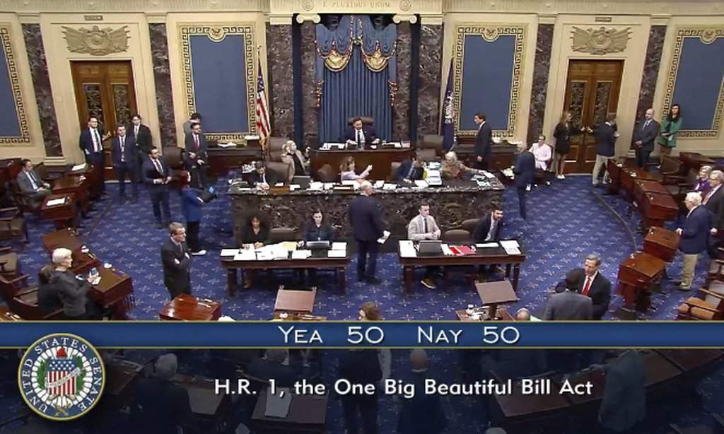 In this image from video from Senate Television, Vice President JD Vance, seated center, breaks a 50-50 tie to push President Donald Trump’s big tax breaks and spending cuts bill over the top, on the Senate floor at the U.S. Capitol, Tuesday, July 1, 2025, in Washington. (Senate Television via AP)