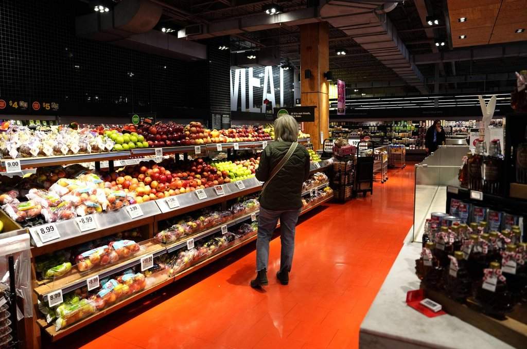 A customer looks for produce at a grocery store in Ottawa, on Wednesday, April 2, 2025.