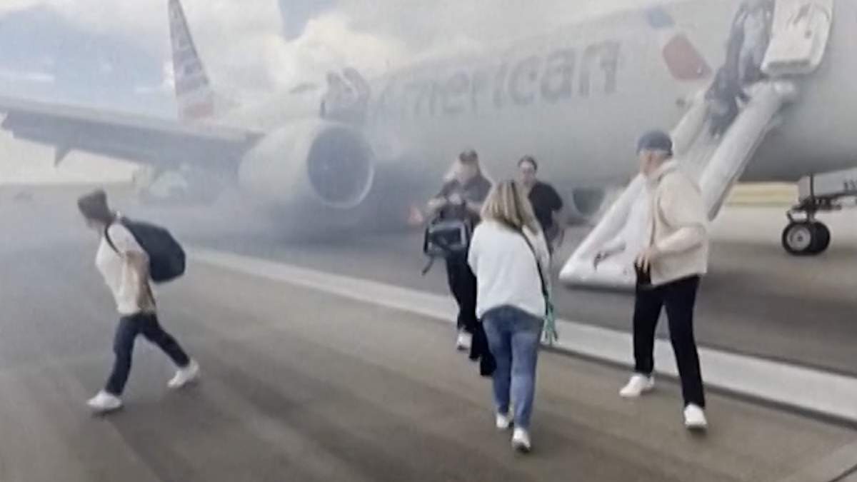 Passengers on an American Airlines flight bound for Miami from Denver evacuate on the tarmac after a landing gear failure halted takeoff procedures on Saturday, July 26, 2025 at Denver International Airport.