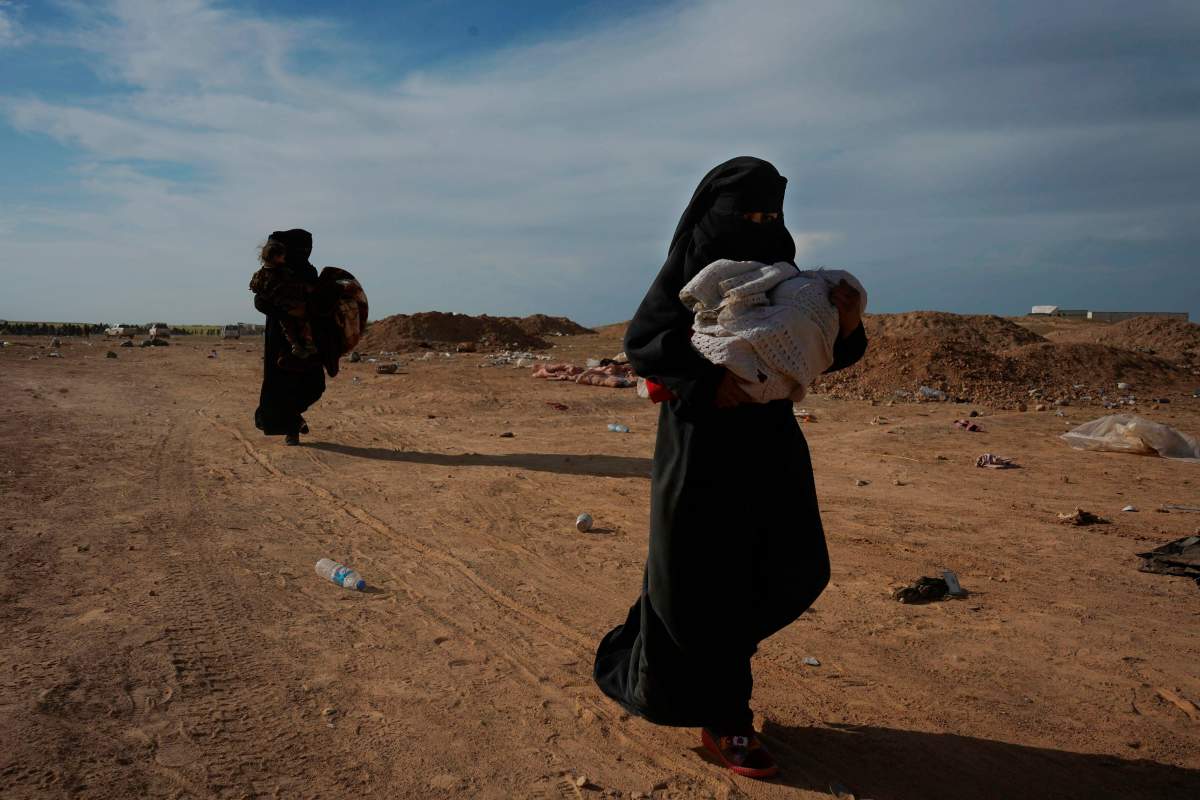 Women evacuated out of the last territory held by Islamic State outside Baghouz, Syria, March 5, 2019. AP Photo/Andrea Rosa.