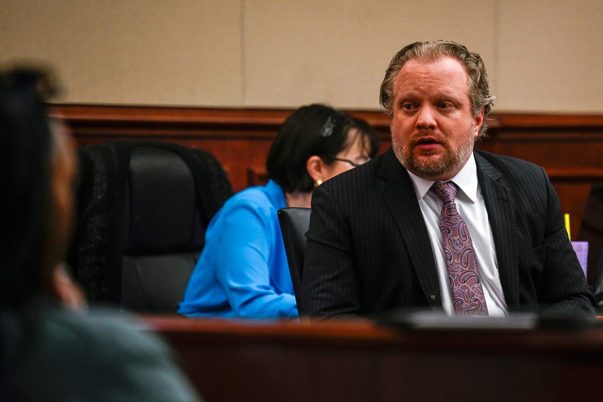 James Craig talks with his family from his seat before opening arguments in his murder trial, as he is accused of killing his wife, at the Arapahoe District Court, Tuesday, July 15, 2025, in Centennial, Colo.
