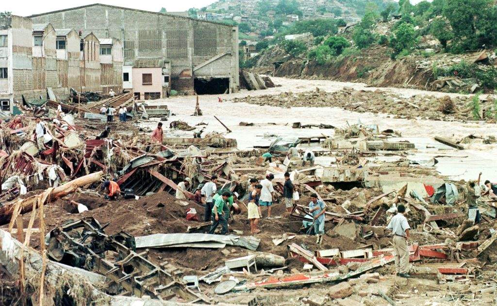 Local residents look through the remains of several businesses that were completely destroyed after being flooded by the rising waters of the Choluteca River that runs through Honduras.